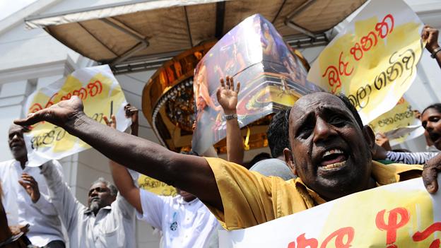 Sri Lanka supporters of the country's main opposition chant slogans and hold banners as they protest outside a casino in Colombo on April 24