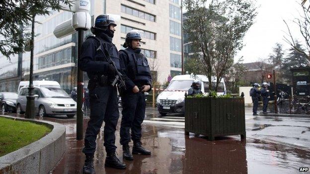 Police officers secure the area near the headquarters of French Central Directorate of Interior Intelligence on 8 January