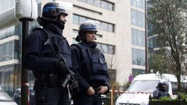 Police officers secure the area near the headquarters of French Central Directorate of Interior Intelligence on 8 January