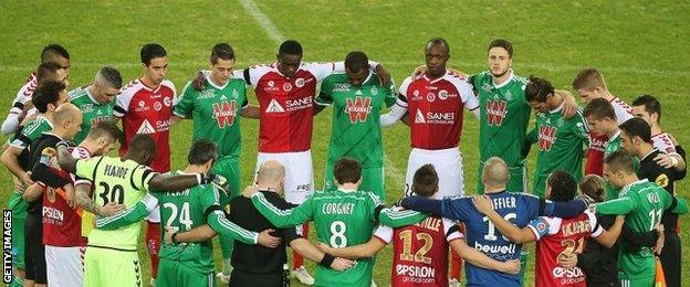 Reims and St Etienne players stood in a circle as they observed a minute of silence in tribute to the victims