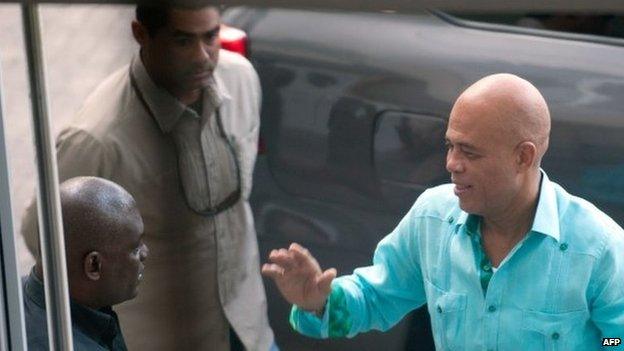 Haitian President Michel Martelly (right) arrives for meetings with members of opposition parties in Port-au-Prince on 17 December 17 2014