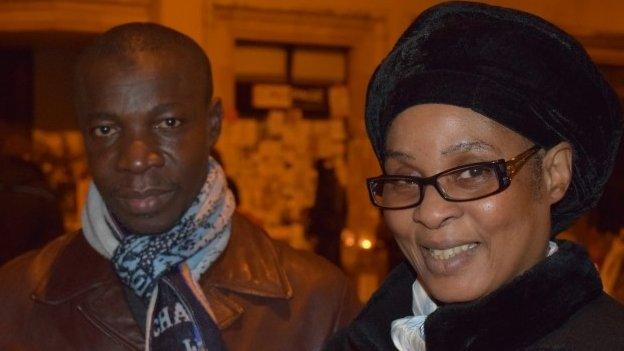 Berthe with his wife Fatoumata at the vigil near the offices of Charlie Hebdo, on Rue Nicolas Appert, Paris. Photo taken 11 January, by Patrick Jackson, BBC News