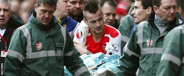 Arsenal defender Mathieu Debuchy carried off with an injury