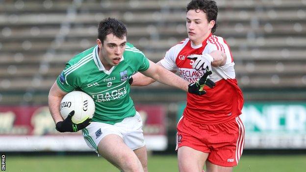 Fermanagh's Ryan Jones is challenged by Derry opponent Kevin Johnston