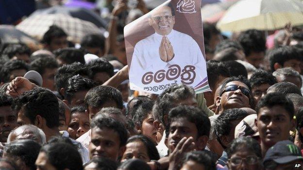 Supporters of President Maithripala Sirisena listen as he addresses the nation outside the Temple of Tooth in Kandy (11 January 2015)