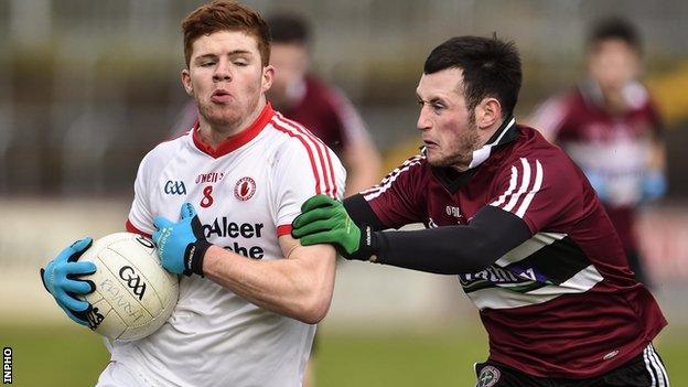 Tyrone midfielder Cathal McShane is tackled by Ciaran McCoey of St Mary's