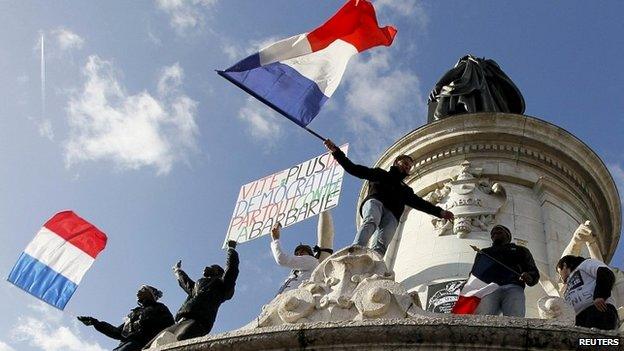 People flying French flags take part in a solidarity march in Paris - 11 January 2015