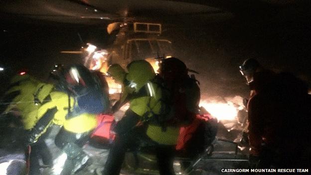 Rescuers taking casualty to helicopter