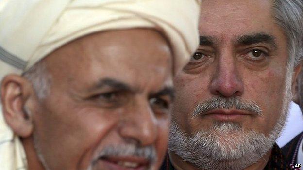 In this file photo taken Saturday, Oct. 4, 2014, Afghanistan's Chief Executive Abdullah Abdullah, right, listens as President Ashraf Ghani speaks