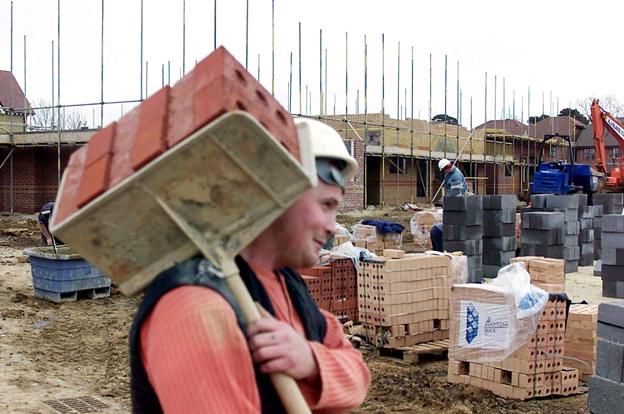 Builder on site carrying hod