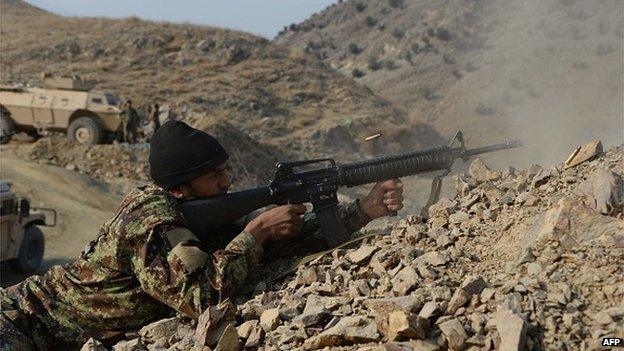 January 3, 2015, an Afghan National Army (ANA) soldier fires during an ongoing anti-Taliban operation in Dangam district near the Pakistan-Afghanistan border in the eastern Kunar province