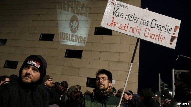 People gather to take part in a protest against anti-immigration movement Patriotic Europeans Against the Islamisation of the West (PEGIDA) at the Jewish synagogue in Dresden