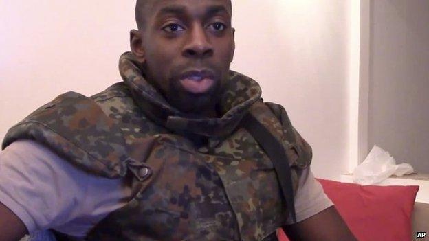 This image made from a video posted online by militants on Sunday, Jan. 11, 2015, shows slain hostage-taker Amedy Coulibaly