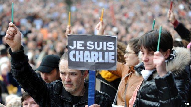 People hold signs "I am Charlie" and pencils during a rally in Brest, western France. Photo: 11 January 2015