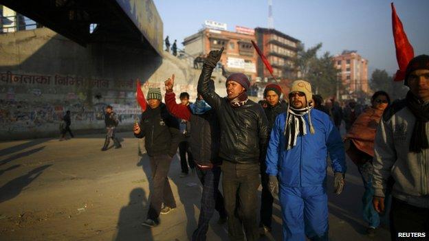 Protesters march along a deserted road during the general strike in Kathmandu 13 January 2015