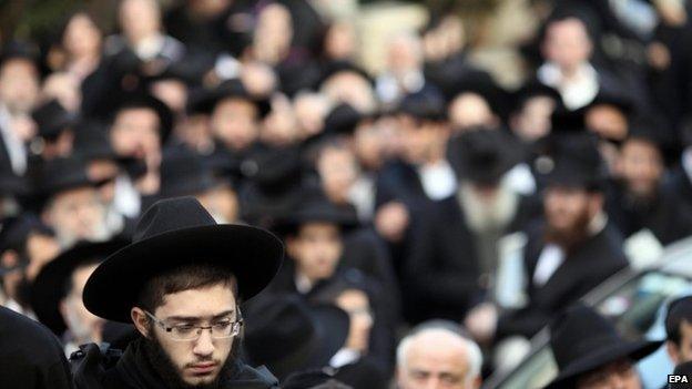 Relatives of Yoav Hattab, a victim of the attack on the Paris kosher supermarket, gather for his funeral near Jerusalem, 13 January 2015