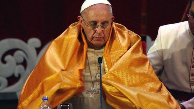 Pope Francis wears a saffron robe during a multi-faith meeting in Sri Lanka