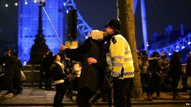 New Year reveller takes selfie with police officer in London