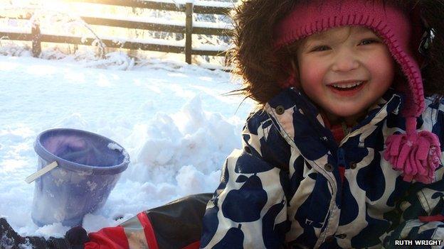 Cara, three, playing in snow