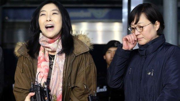 Korean-American Shin Eun-Mi (L) speaking to the media as she is deported from South Korea at an immigration office of Incheon airport while former leftist politician Hwang Sun (R), a pro-unification activist, stands with her.