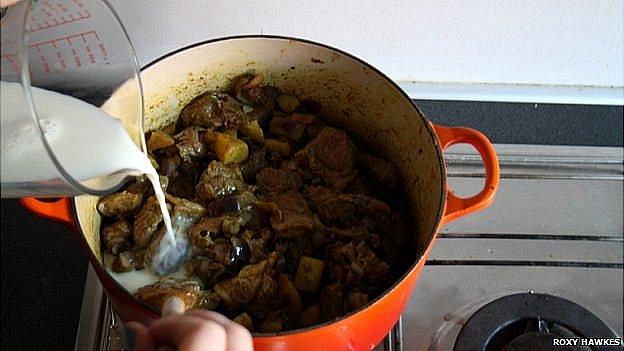 Milk being poured into the Victorian curry recipe