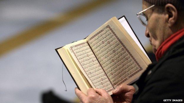 A muslim reads a book in the Grande Mosque in Strasbourg