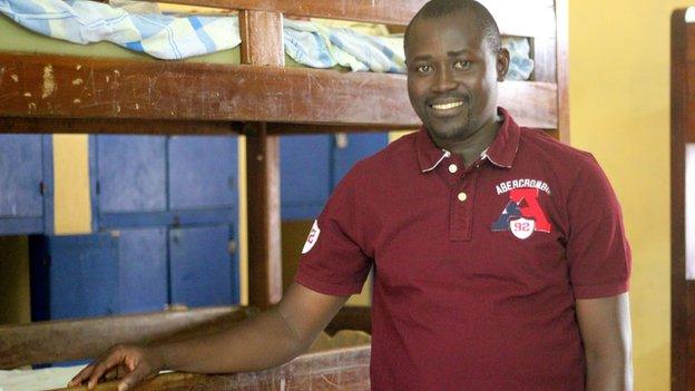 Carmel N'Guessan, secretary general, standing beside Wilfried Bony's old bed in the dorm room.