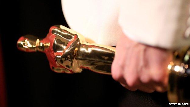 Oscar statue in hand