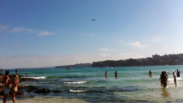 Swimmers retreat from the water after a shark alert at Bondi beach, Jan 2013