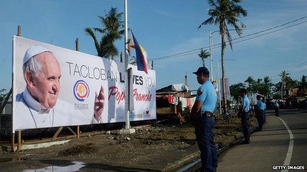 Philippine National Police stand guard along the national highway during security rehearsal ahead of the papal visit to the area on January 15, 2015 in Tacloban, Leyte, Philippines