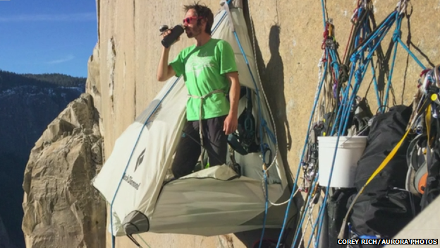 Having a drink in a tent hanging from cliff face