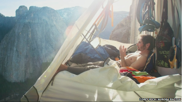 Relaxing in a tent hanging from cliff face