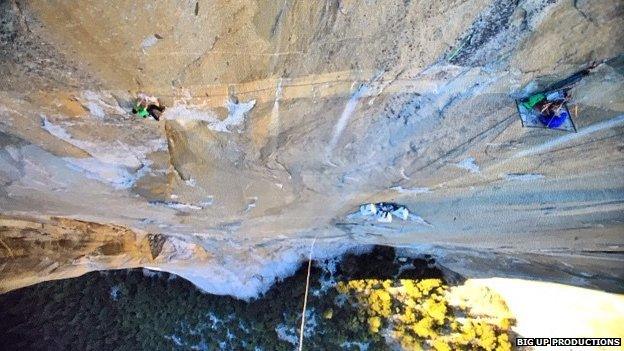 Scaling El Capitan, gripping by finger tips and tent hanging from cliff face