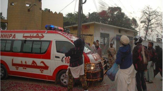 Pakistani residents shower rose petals over an ambulance carrying the body of executed prisoner Muhammad Saeed Awan, a member of the banned Lashkar-e-Jhangvi militant group which is linked to Al Qaeda, outside the central jail in Karachi on January 15, 2015