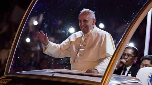 Pope Francis waves to the faithful upon his arrival in Manila city