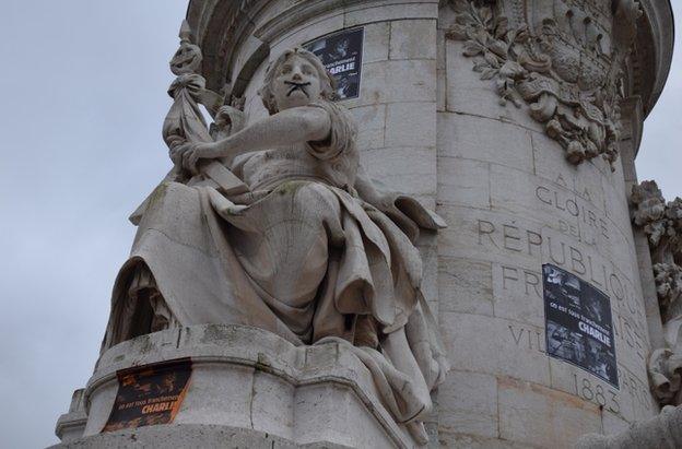 A statue on Place de la Republique, Paris, symbolically "gagged" by protesters, 10 January 2015