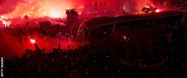 Real Madrid team bus is met by fans