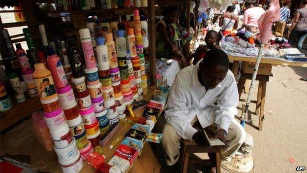 A trader selling beauty products, including skin lightening creams, in Guinea