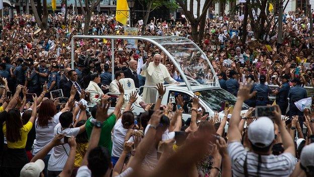 Pope Francis waves to the faithful upon his arrival at Manila Cathedral on January 16, 2015 in Manila, Philippines