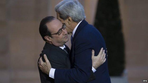 French President Francois Hollande (L) greets US secretary of state John Kerry (R) as he arrives for a meeting at the Elysee Palace in Paris, France, 16 January 2015