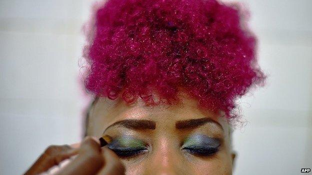 A model has her makeup done backstage at the annual Nairobi Fashion week in Nairobi on November 28, 2014