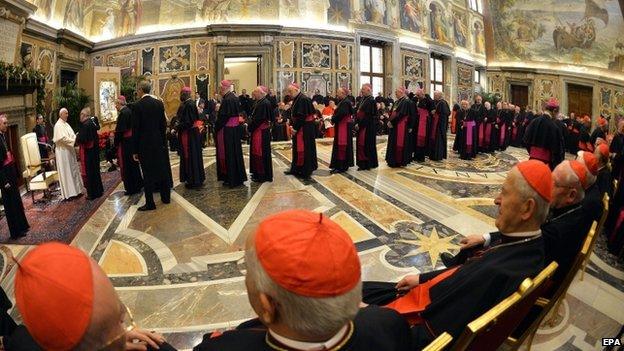 Cardinals line up to take their leave of Pope Francis at the end of the audience of the Curia, the administrative council of the Holy See