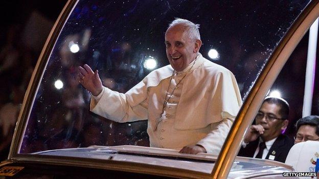 Pope Francis waves to the faithful upon his arrival in Manila city