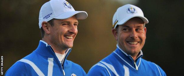 Team Europe's Justin Rose of England and Henrik Stenson of Sweden smiles as they walk away from the first tee during the first day of the Ryder Cup at the Gleneagles golf course in Gleneagles.