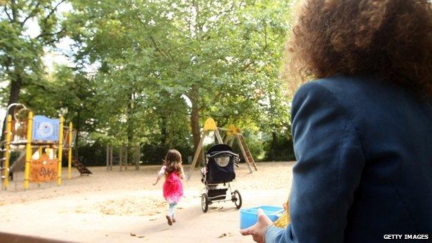 A woman watches her child in a German park