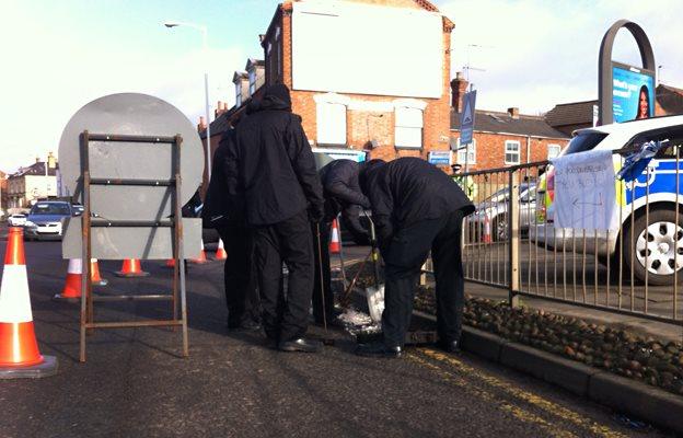 Police lift drain covers along Barrack Road, Northampton