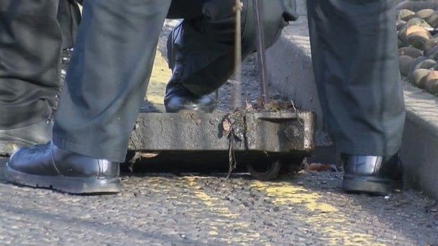 Police lift drain covers along Barrack Road, Northampton