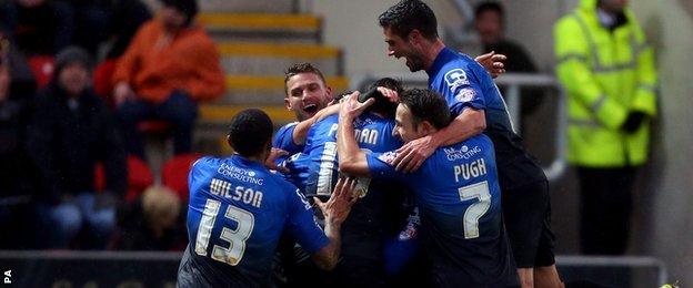 Bournemouth players rush to congratulate Tommy Elphick as he celebrates scoring the first goal