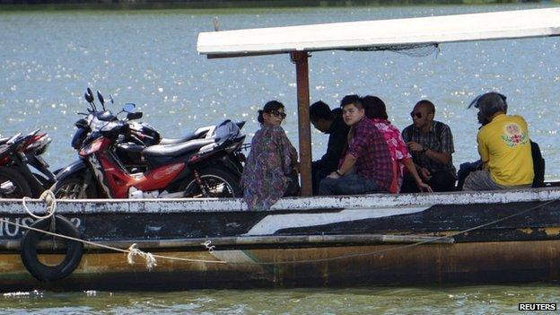 Relatives of death row prisoners ride a small ferry to at Wijayapura quay in Cilacap, Central Java