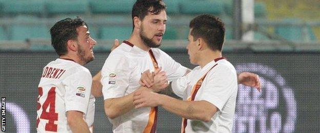 Roma's Mattia Destro is congratulated by his team-mates